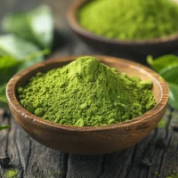 Green tea powder in a wooden bowl, the source of the green tea catechins in MounjaMelt